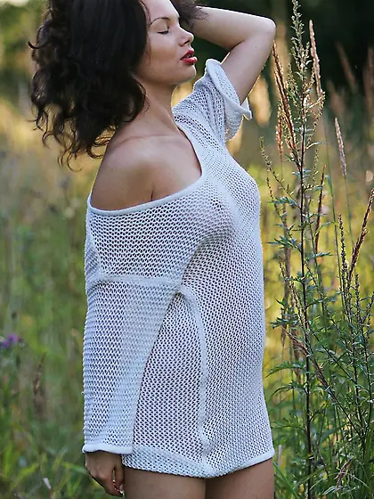 Half naked model playing with her hair while teasing you happily