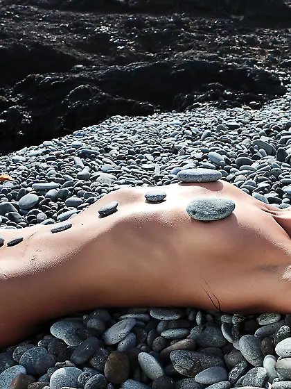 Maria S enjoys in posing on the beach,  as the waves hug her hot