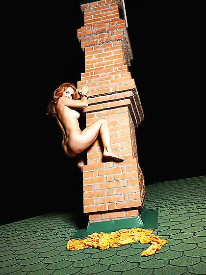 Beautiful red haired doll Natalia A bares and climbs up a column