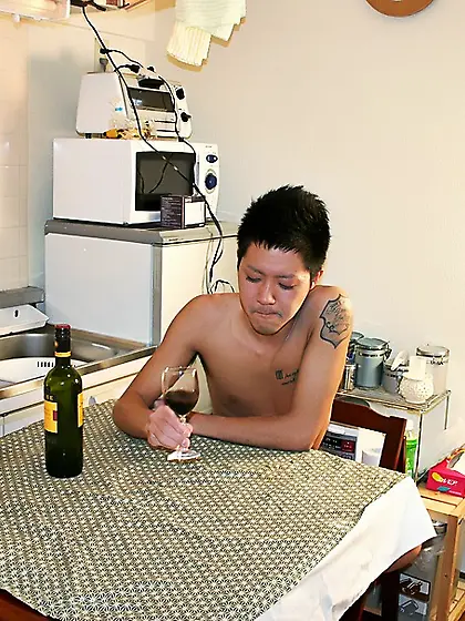 Naked dude drinks wine