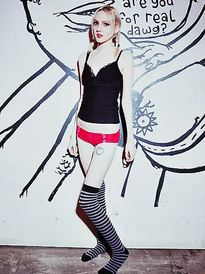 Small-tittied skinny girl in striped over-the-knee socks poses b