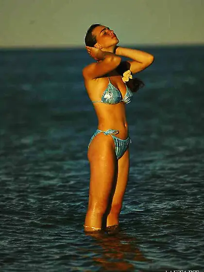 Bikini-wearing teenage nudist goes topless while enjoying the wa