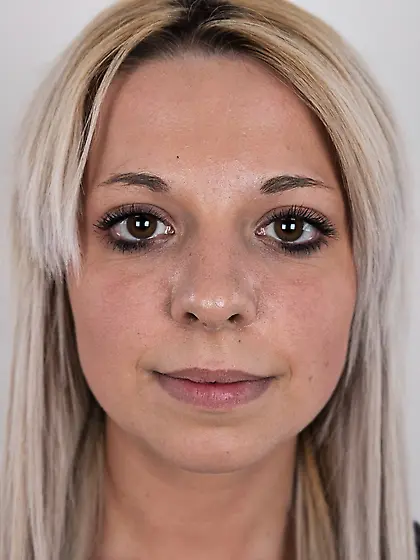 Sexy model wears bright pink lingerie under a gloomy black dress