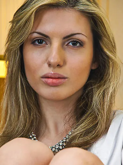 Classic blonde beauty sits