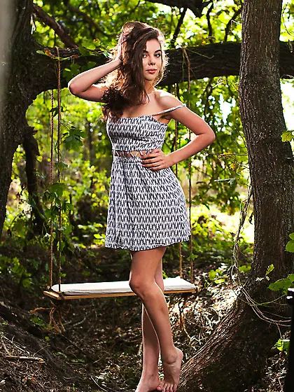 Wild-haired brunette takes off her summer dress to play around n