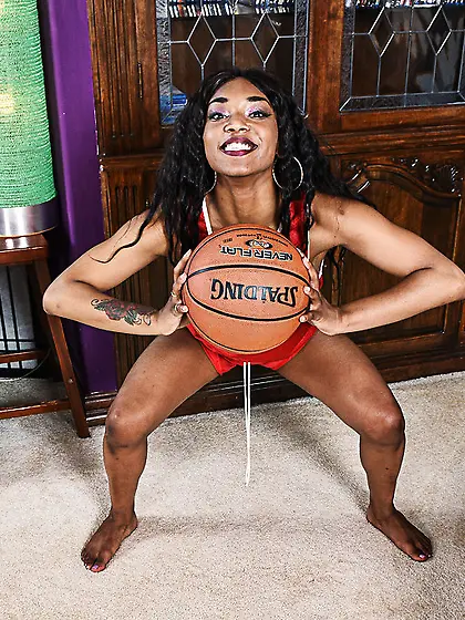 Black girl Sizi Sev with a basketball sits on a blue chair and s