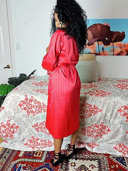 Black love with wonderful fuzzy hair opens her red robe showing