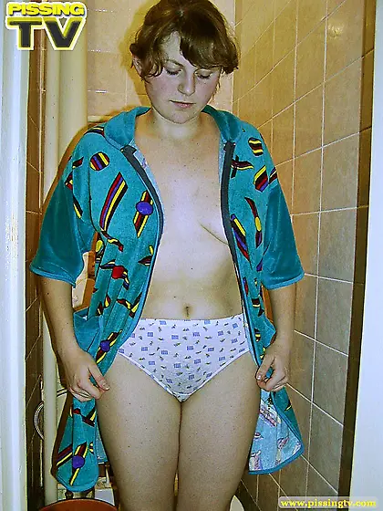 Teen girl pisses in the toilet