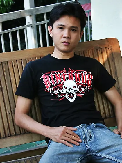 Handsome asian guy sits