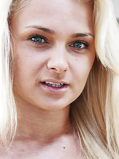 Young blonde with beautiful green eyes shows assets in provocati