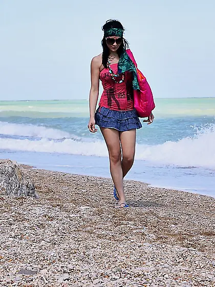 Busty brunette model Adrianne Black strips on the beach and show