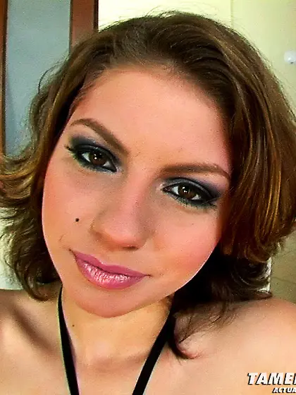 Brunette lies white couch