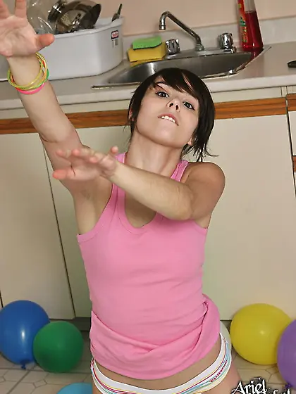 Ariel Rebel plays with colorful balloons and with her own firm b