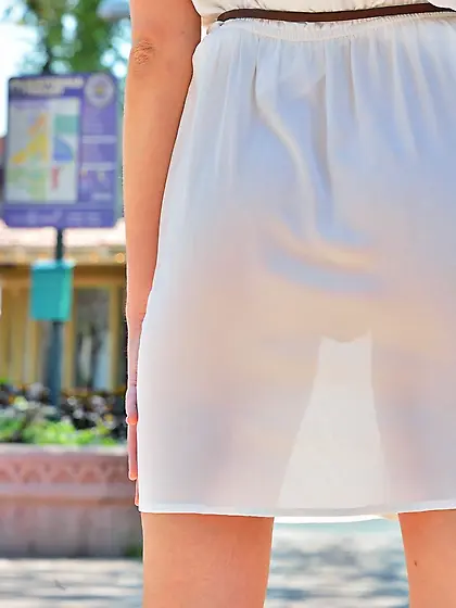 Small booty blonde lifts up her dress and masturbates in the par