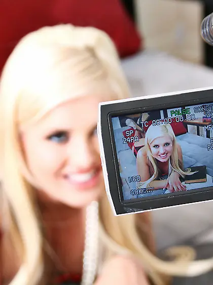 Andi Anderson takes her sexy black stockings opn the bed and sho