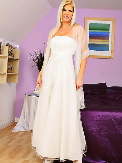 Busty bride Amy G in sexy stockings removes her snow white weddi