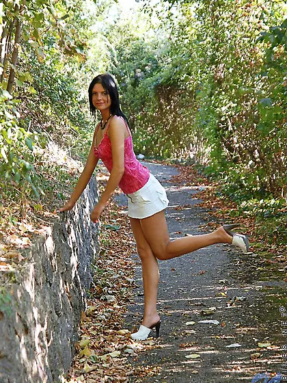 Teeny brunette Monika Benz in white mini-skirt pulls off her bla