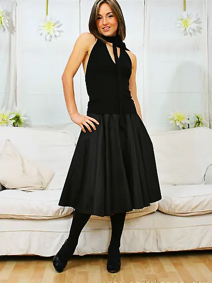 Smiling kitty Melanie in black stockings and garters removes her