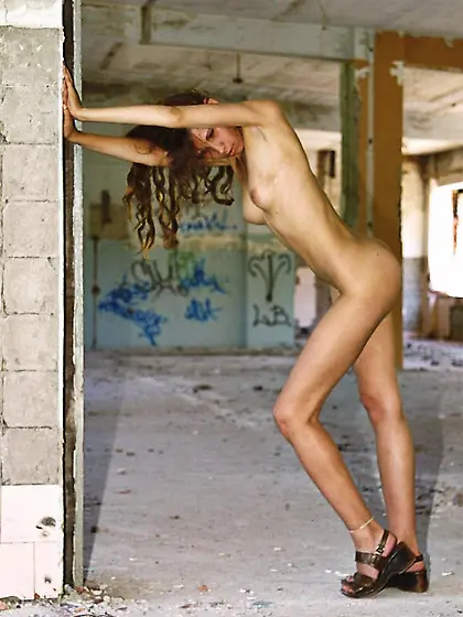 Brunette celebrates her freedom by roaming an abandoned building