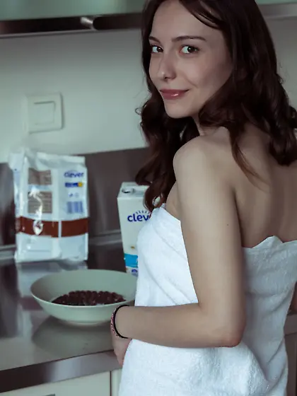 Brunette enjoys her cereal and strips naked to show you somethin