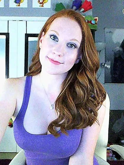 Seducing bimbo Lucy OHara holds the dildo between big boobs and