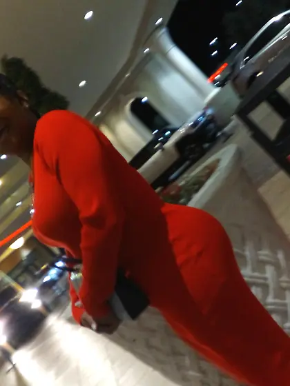Red dress juicy GILF with phat ass at the casino.