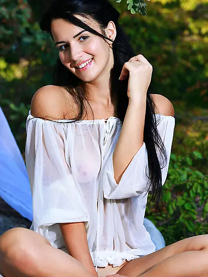 Gorgeous teen brunette with tan lines exposes her pussy outdoors