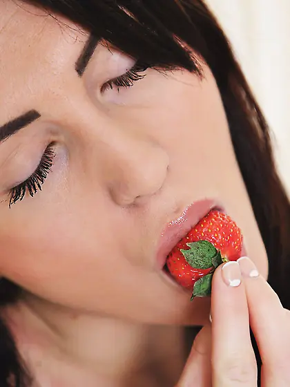 Brunette eats her strawberry in a suggestive way,  strips naked V