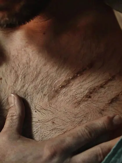 Scary Krampus punishing tattooed dude in the living room