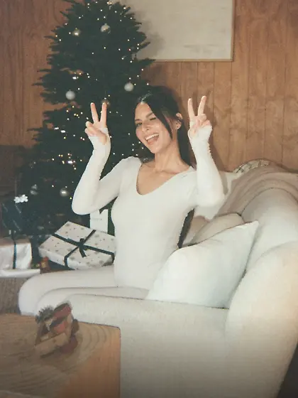 Olivia Munn in white outfit at a Christmas