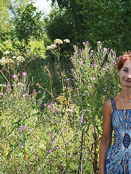 In blue dress in field