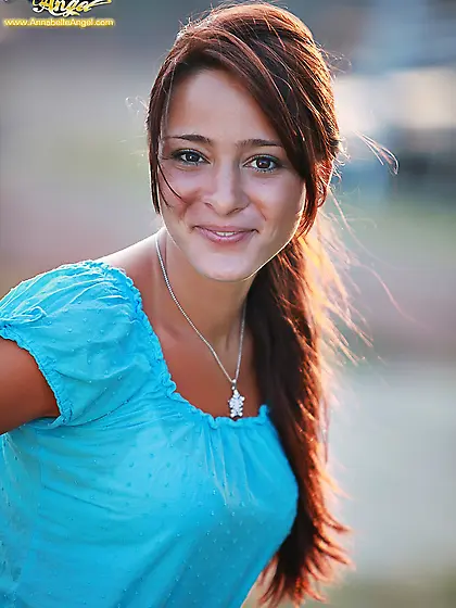 Annabelle Angel slowly takes her blue shirt outdoors and shows h