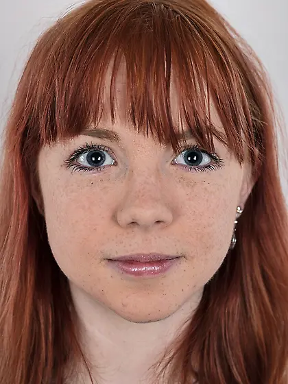 Female with red hair and colored rose tattooed on pale body stri