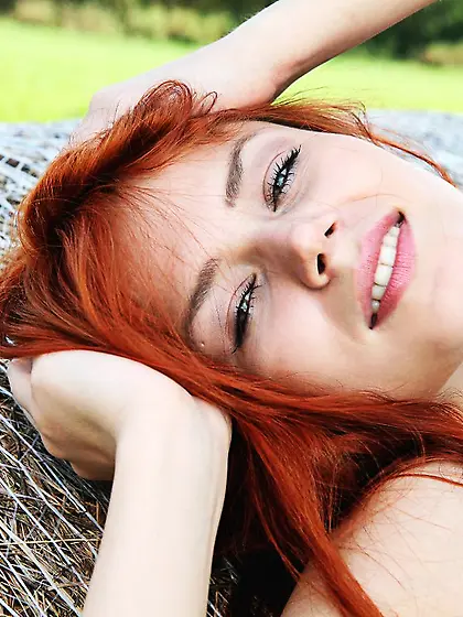 Sweet redhead Kami A gives a delicious outdoor striptease with n