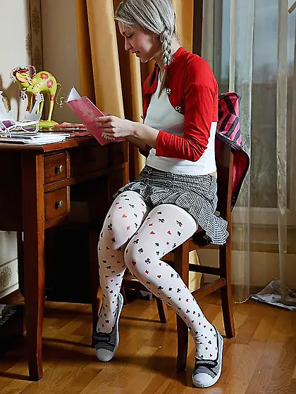 Pigtailed blonde in white stockings showing off her pussy on cam