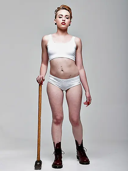 Pale-skinned bitch with short red hair and tongue piercing holds