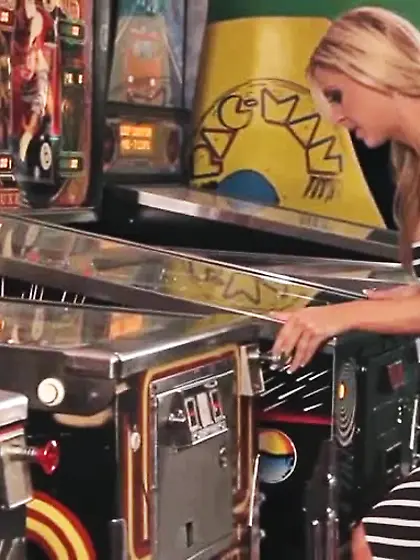 Racy lesbian fucking next to a pinball machine