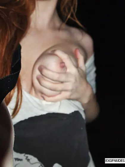 Redhead posing naked outdoors