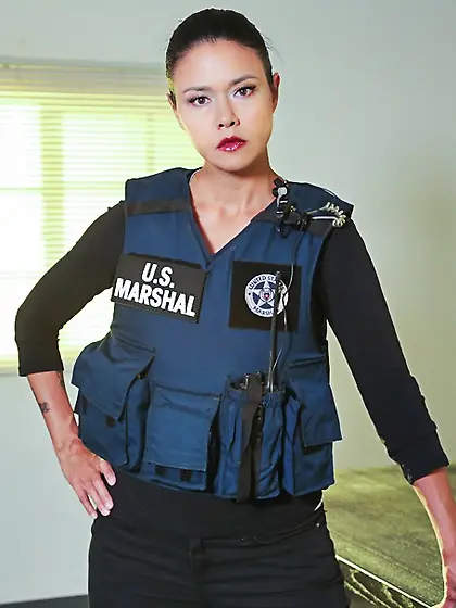 Inked brunette policewoman undressing