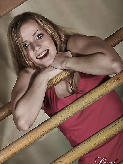 Good-looking sweetheart performs amazing striptease near wooden