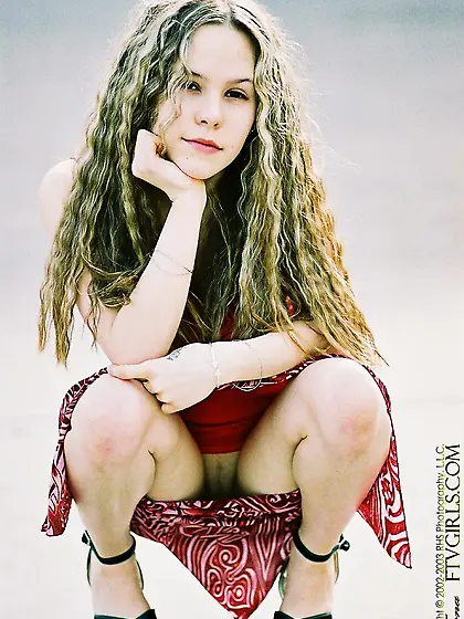 Young girl with awful frizzy hair climbs a statue to flash pussy