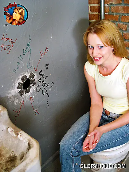 Shy-looking blonde with blue eyes sucking cocks via a glory hole