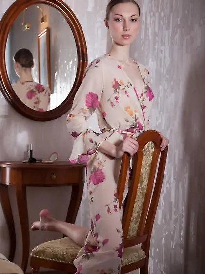 Floral get-up hottie looks at her own reflection before strippin