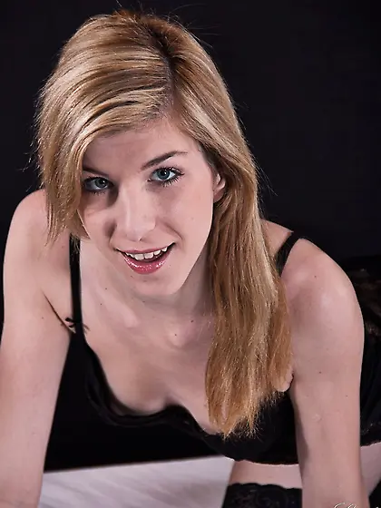 Small-tittied cutie in black stockings reveals body lying on the