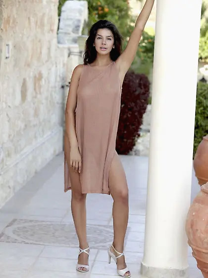 With her intense gaze fixed on you,  Adelle strips in public