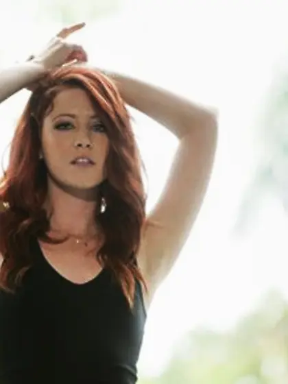 Hot red-haired stunner removes black dress to show off her slim
