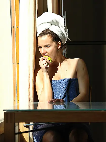 Brunette eats an apple in a smug fashion and shows her pussy as