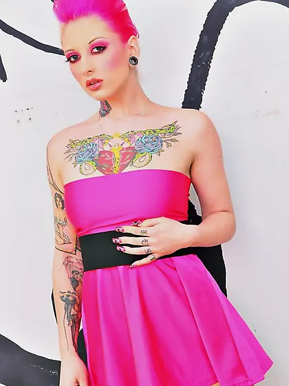 Female with dyed hair and a pink dress on allows her girls to ha