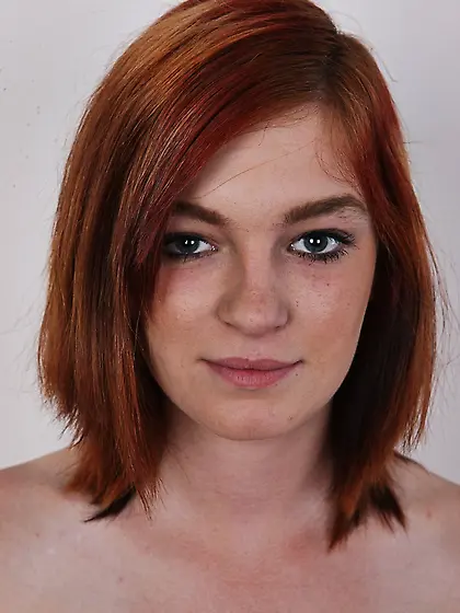 Pretty redhead strips orange
