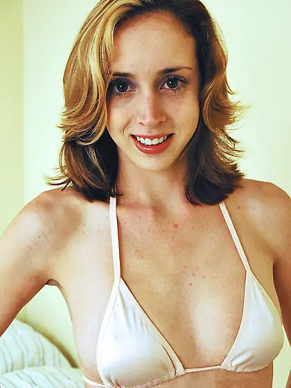 Alluring blonde vixen Kelly Wells strips her clothes and shows h